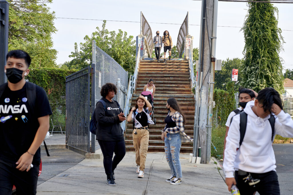 Students descend down a staircase as they make their way toward Pan American High School in Elmhurst.